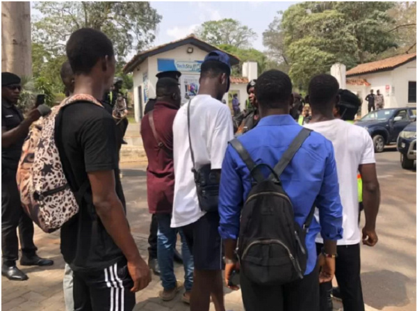 Some police officers and students at UG entrance