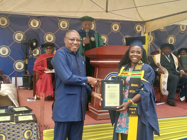 Dr Clement Apaak, presents an award to a GCTU graduate