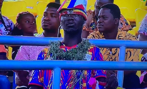 A dejected Hearts of Oak supporter