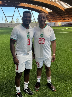 Asamoah Gyan (left) and CAF President Patrice Motspe