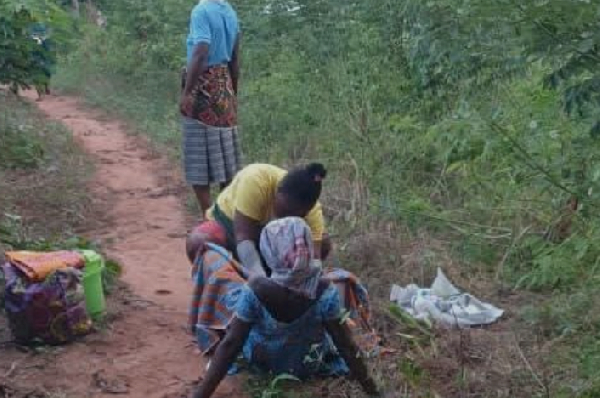 The pregnant woman being assisted by the midwife to deliver