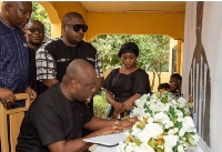 Lawyer Justin Kodua signing Atsu's book of condolence