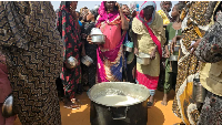 Refugees gather for food