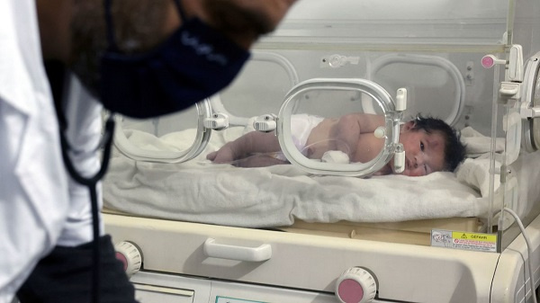 A baby girl receives treatment inside an incubator at a children's hospital in Afrin, Syria, on Tues