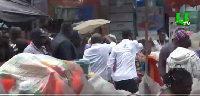 Dr Mahamudu Bawumia together with his team campaigning in the rain