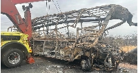 The charred remains of the bus are pictured on Monday.