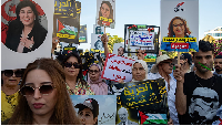 Demonstrators hold photos of detained politicians and activists during a protest