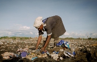A woman scavenges through garbage at Dandora in Nairobi, one of the largest dumpsites in the world