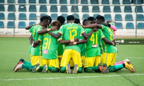 Aduana Stars players pray before a game