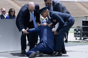 Biden being helped up after falling