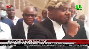 Kpessa-Whyte in spectacles led by one of his lawyers outside the court after conviction