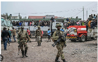 M23 rebels escort government soldiers and police who surrendered to an undisclosed location in Goma