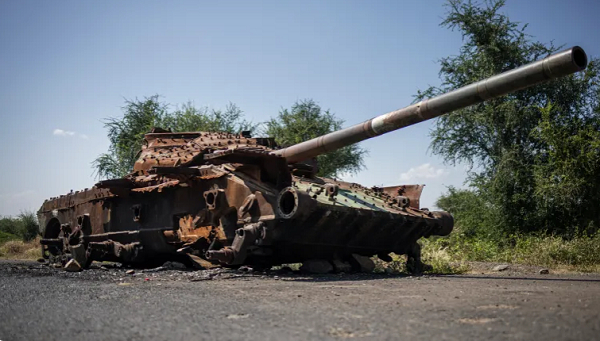 The charred remains of a T-72 tank lie on a road connecting Shiraro to Shire in Tigray, Ethiopia