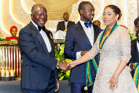 Asantehene Otumfuo Osei Tutu II (L) shakes hands with Angela List (R)