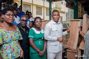 MP for Tarkwa-Nsuaem Constituency and others presenting furniture to a school