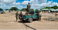 Somalia National Army soldiers patrol the Dhobley open Market in Lower Juba on April 17, 2024.