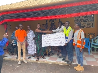 Genser Energy's Issah Mohammed present the cheque to traditional rulers