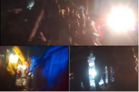Screenshots of rescuers attempting to retrieve the body of a woman trapped beneath the rubble