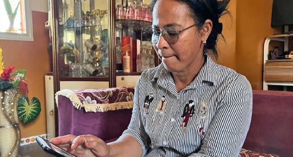 Razanasoa Edmondine looking at the photos of her new grandson