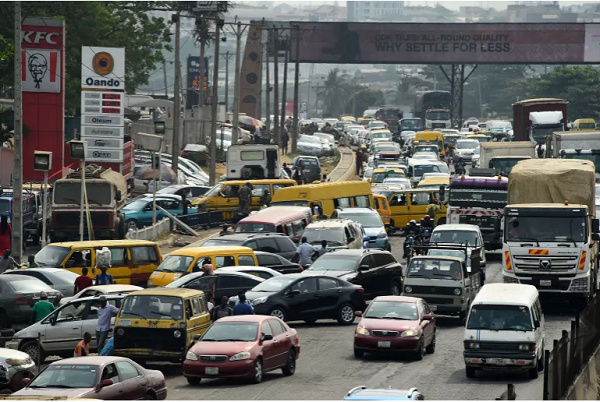 Drivers wait in line to buy fuel at filling station, causing traffic gridlock Lagos' Ibadan expressw