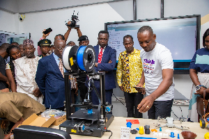 Dr Yaw Adutwum inspecting some items at the laboratory