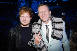 Ed Sheeran and Macklemore performing together on stage in 2014