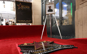 A photo of late actor Chadwick Boseman is set on an easel