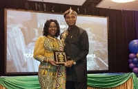 Ambassador Nancy Q. Sam receiving her award in Miami