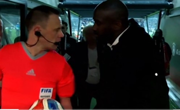 Referee Stuart Attwell (in red) was approached by Otto Addo over penalty decision