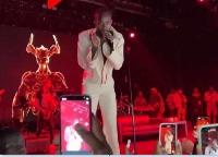 Black Sherif performing at the Palladium Theatre with the Baphomet being projected at the background
