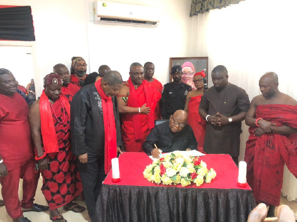 Prof. Mike Oquaye signing the book of condolence
