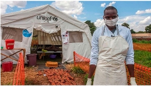 Medical worker stands in front of a ward of a Cholera Treatment Centre in Malawian capital Lilongwe