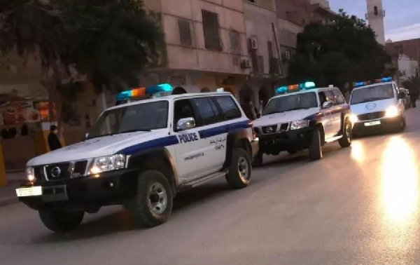 Moroccan police stand behind a sand wall in Western Sahara