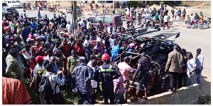 Residents gather as police remove the bodies from the scene on July 14, 2024.