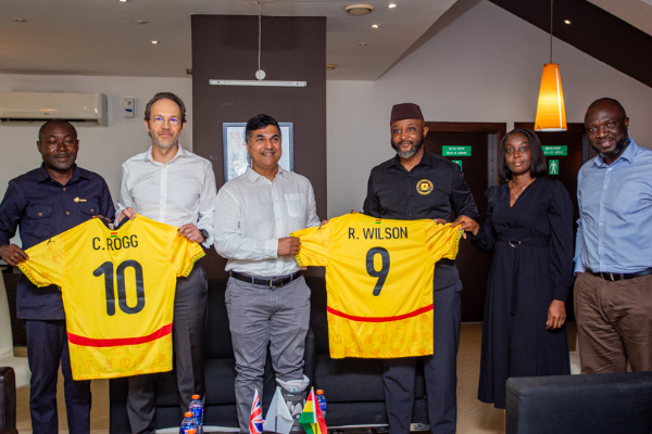 (2nd from left) UK High Commissioner Christian Rogg receives customized Black Stars jersey
