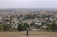 A man runs in front of the cityscape of Mekele, Tigray Region, Ethiopia, on June 25, 2023
