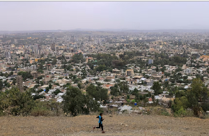 A man runs in front of the cityscape of Mekele, Tigray Region, Ethiopia, on June 25, 2023