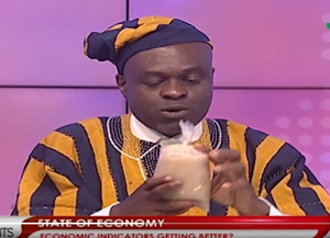 Martin Kpebu is seen holding the porridge on live TV