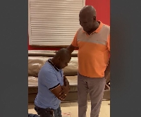 Kwabena Bobie Ansah on his knees as Sam Jonah prays for him