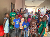 A photo of Ernestina Serwaa Asante and some children of Nyamedua Children's Home