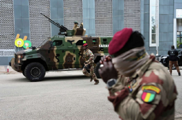 Guinean soldiers secure the area outside a polling station before Mamadi Doumbouya arrives
