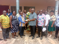 Ebenezer Okletey Terlabi presenting the money to the directorate