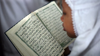 A muslim woman reads and studies the Quran