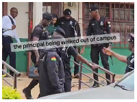 Snipped of the police escorting the principal off campus over a protest on poor living conditions