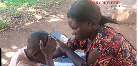 A Primary Four pupil struggles to read four-letter words during a learning assessment