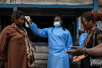 A health worker checks for Ebola at a Goma checkpoint in DR Congo