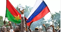 Young pipo dey wave Russia flags for di streets of Ouagadougou
