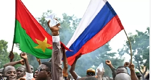 Young pipo dey wave Russia flags for di streets of Ouagadougou