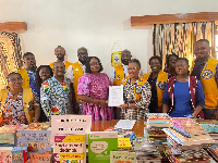 Dr. Helena Asamoah-Hassan and members of the club presenting the books to one of the schools