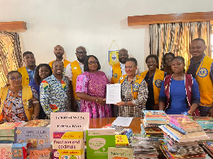 Dr. Helena Asamoah-Hassan and members of the club presenting the books to one of the schools